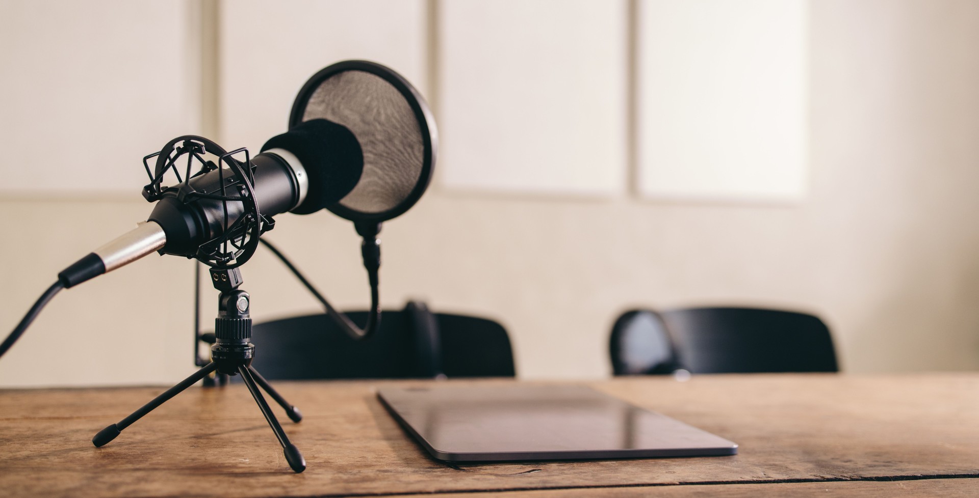 Microphone and pop shield placed on a table in a home studio